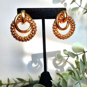 Statement gold tone earrings.